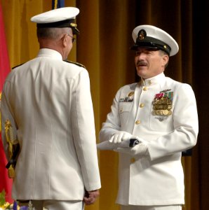 US Navy 050722-N-5390M-003 Master Chief Petty Officer of the Navy (MCPON) Terry Scott presents Adm. Vern Clark, Chief of Naval Operations (CNO) with Clark's personal flag during a change-of-command ceremony