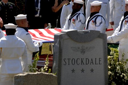US Navy 050723-N-5390M-004 The American flag draped over the casket of retired Vice Adm. James B. Stockdale is prepared for presentation to the family by a ceremonial guard