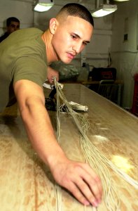 US Navy 050705-N-0361G-018 U.S. Marine Corps Sgt. Juan Franco performs a canopy inspection on an A-P22P-11 parachute aboard the nuclear-powered aircraft carrier USS Nimitz (CVN 68)