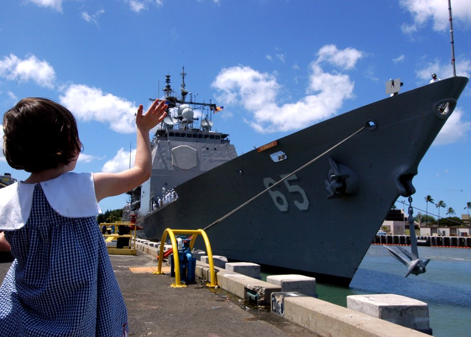 US Navy 050725-N-3019M-003 A family member waves goodbye as the guided missile cruiser USS Chosin (CG 65) departs Naval Station Pearl Harbor
