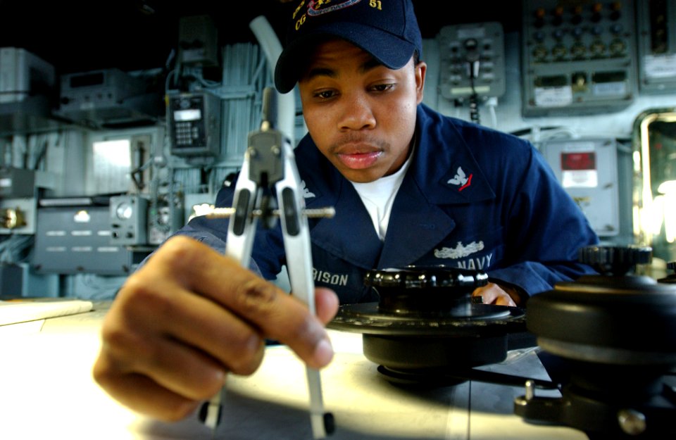 US Navy 050809-F-4883S-055 Quartermaster 3rd Class Michael Harrison plots a course in the pilot house of the guided missile cruiser USS Thomas S. Gates (CG 51) as the ship makes its way out to sea to begin PANAMAX exercises