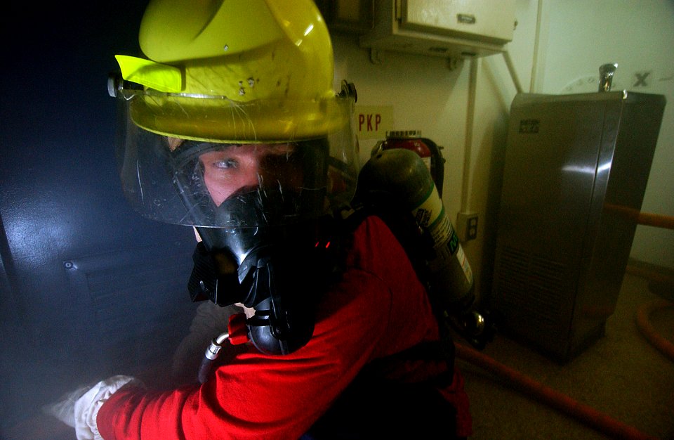 US Navy 050727-C-3292S-522 Petty Officer 2nd Class Chris Walker tends a hose during a firefighting drill aboard the Coast Guard Cutter Bear (WMEC 901)
