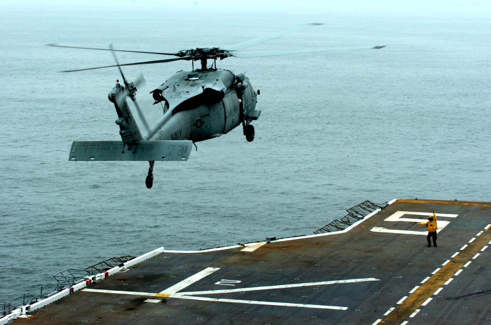 US Navy 050718-N-9866B-031 An MH-60S Seahawk helicopter, assigned to the Blackjacks of the Helicopter Sea Combat Squadron Two One (HSC-21), takes off from the flight deck of the amphibious assault ship USS Peleliu