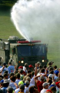 US Navy 050726-N-9769P-009 A U.S. Army fire truck provides relief from the heat as thousands of Boy Scouts stand hoping to hear the President of the United Stated speak at their opening ceremony as part of the National Scout Ja