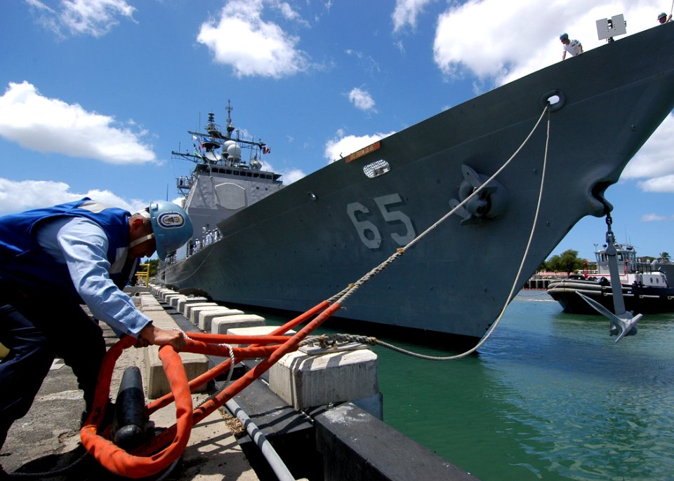 US Navy 050725-N-3019M-002 Boatswain's Mate 3rd Class Davian Begay casts off a mooring line as the guided missile cruiser USS Chosin (CG 65) departs Naval Station Pearl Harbor