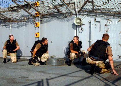US Navy 050707-N-4374S-006 Sailors assigned to the USS Samuel B. Roberts (FFG 58) Visit, Board, Search and Seizure (VBSS) team perform a tactical maneuver aboard the guided missile cruiser USS Thomas Gates (CG 51)