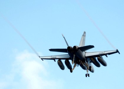 US Navy 050809-N-3488C-037 An F-A-18E Super Hornet flies over USS Kitty Hawk (CV 63) as it conducts a wave-off