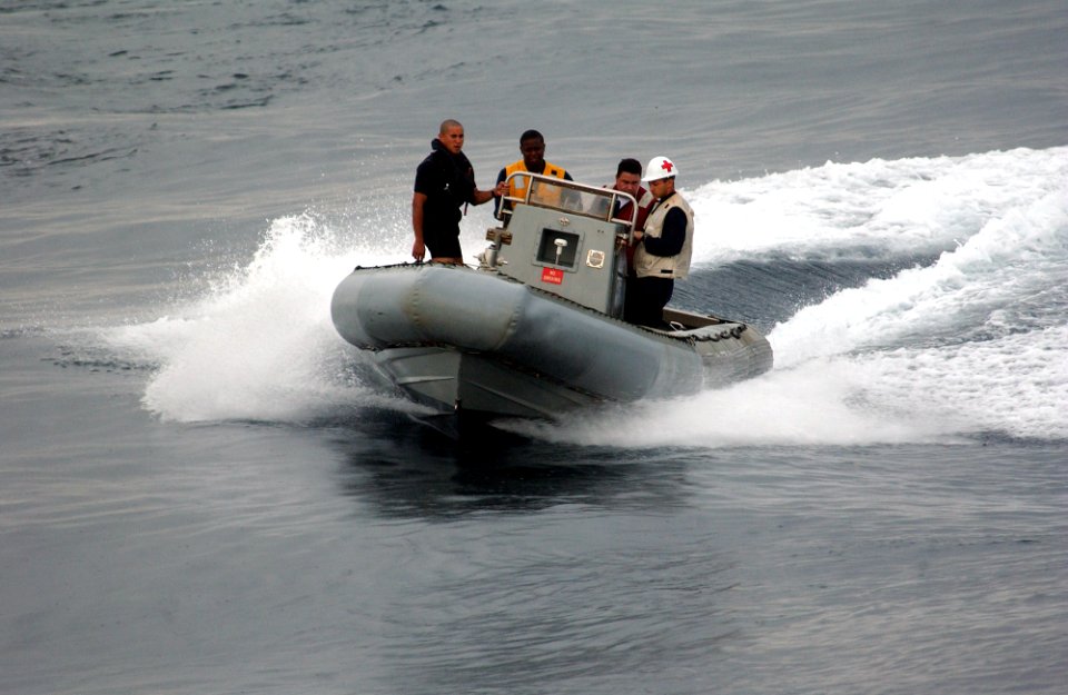 US Navy 050810-F-4883S-040 U.S. Navy Sailors from the guided missile cruiser USS Thomas S. Gates (CG 51) bring a rigid hull inflatable boat around to pick up a Visit Board Search and Seizure Team for a drill during PANAMAX 2005