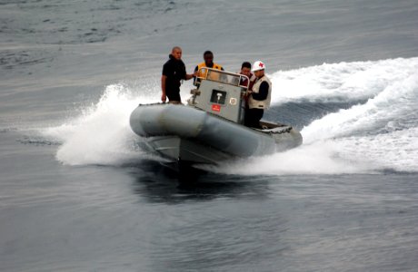 US Navy 050810-F-4883S-040 U.S. Navy Sailors from the guided missile cruiser USS Thomas S. Gates (CG 51) bring a rigid hull inflatable boat around to pick up a Visit Board Search and Seizure Team for a drill during PANAMAX 2005