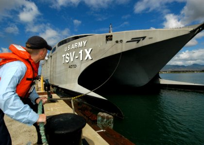 US Navy 050811-N-3019M-002 Cytological Technician 3rd Class Erik Horner, assigned to the guided missile cruiser USS Lake Erie (CG 70), casts off a mooring line as the U.S. Army ship TSV-1X Spearhead departs