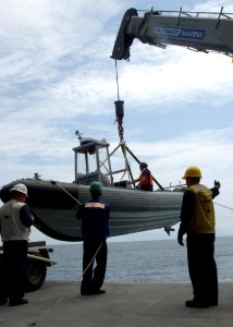 US Navy 050812-F-3177P-011 U.S. Naval Personnel aboard the High-Speed Vessel Swift (HSV 2) prepare to deploy a small Rigid Hall Inflatable Boat for a combined mine countermeasure evolution photo