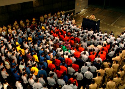 US Navy 050804-N-0962S-189 Master Chief Petty Officer of the Navy (MCPON) Terry Scott speaks to Sailors about the importance of personal readiness at an all hands call in the well deck aboard the amphibious assault ship USS Bat photo