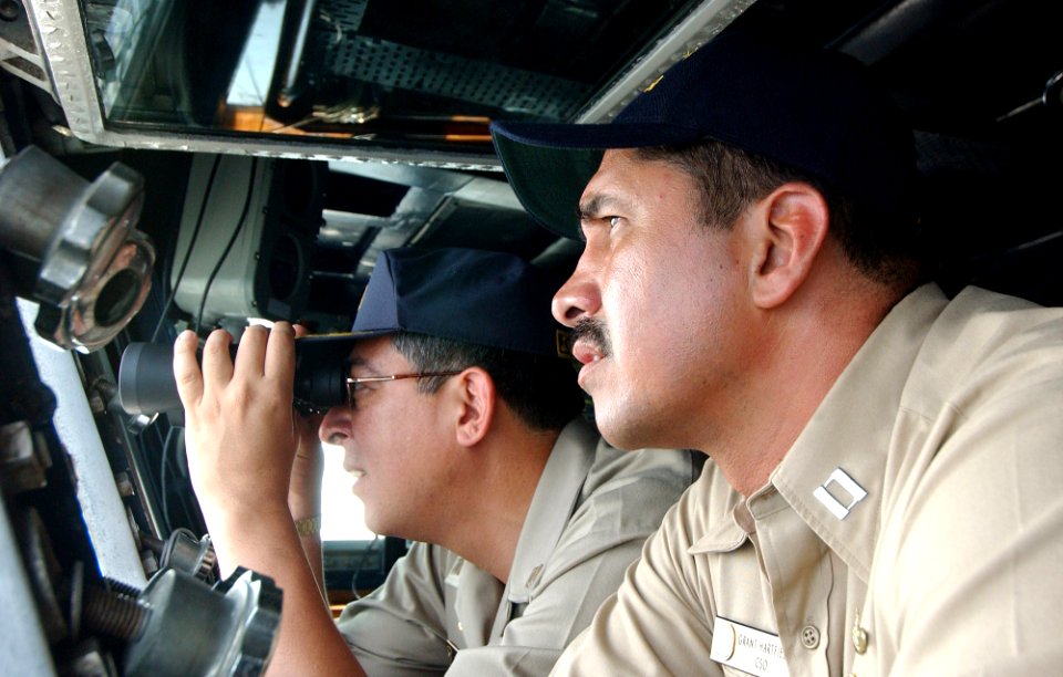 US Navy 050812-F-4883S-180 U.S. Navy Lt. Grant Hartfield, foreground, looks for vessels of interest with Peruvian Navy Capt. Jorge Moreno aboard the Peruvian frigate BAP Villavicencio (FM 52)