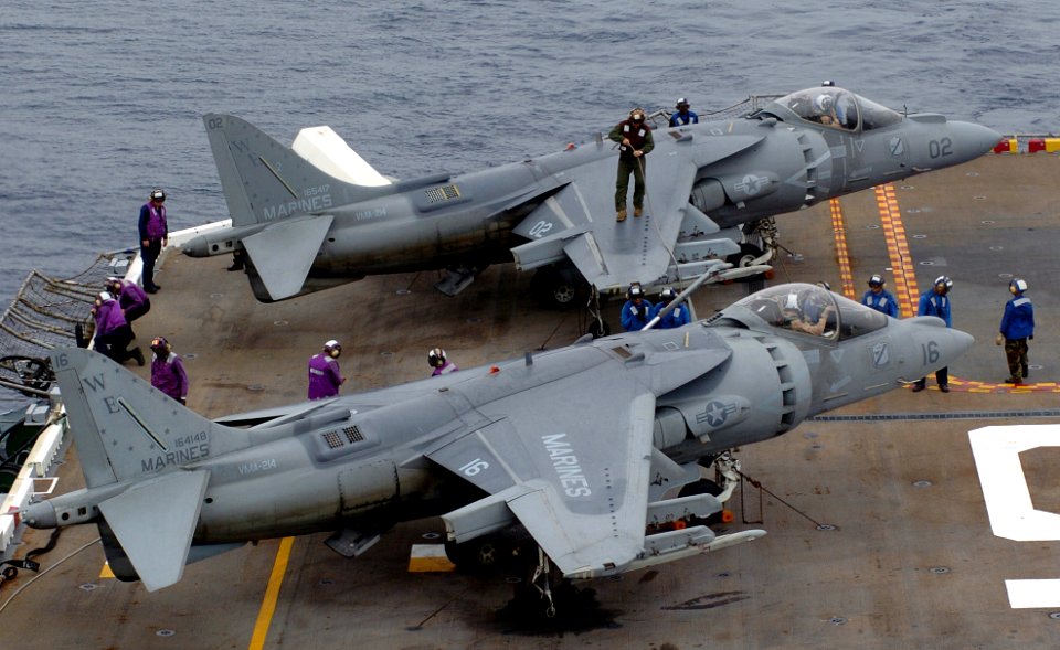 US Navy 050804-N-9866B-001 Sailors work together to fuel a Marine Corps AV-8B Harrier II, assigned to the Blacksheep of Marine Attack Squadron Two One Four (VMA-214)
