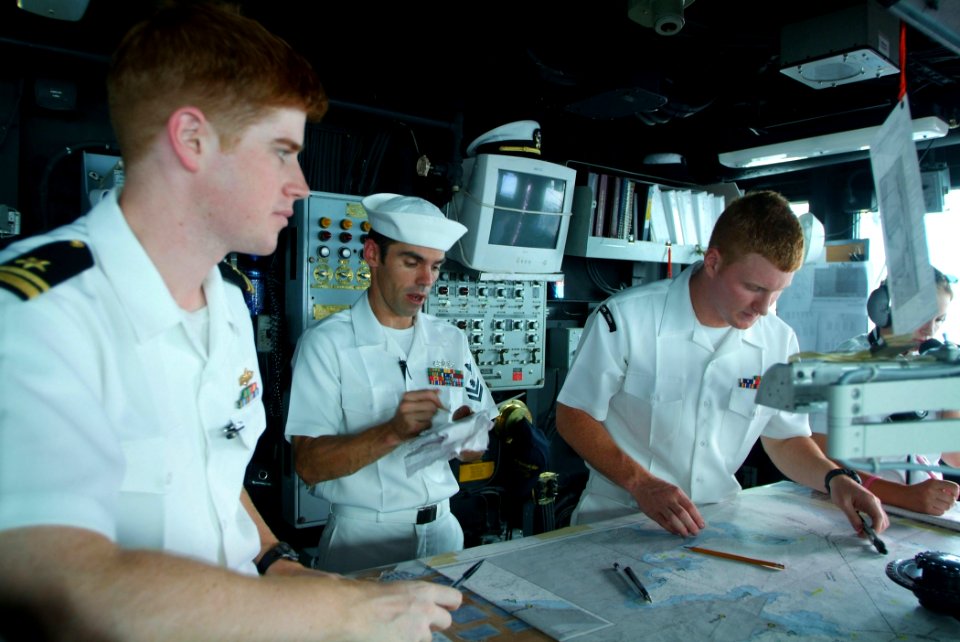US Navy 050815-N-4772B-044 From left, Navigator Lt.j.g. Timothy Shugert, Quartermaster 2nd Class Jeremy Spaulding and Quartermaster 3rd Class Paul R. Keays help navigate the amphibious dock landing ship
