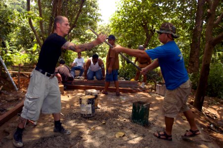 US Navy 050817-N-4104L-058 Damage Controlman 1st Class Dean Marzano, left, assigned to USS Safeguard (ARS 50), shares a tool with a member of the Philippine Navy during a gazebo-building community service project in Olongapo, P