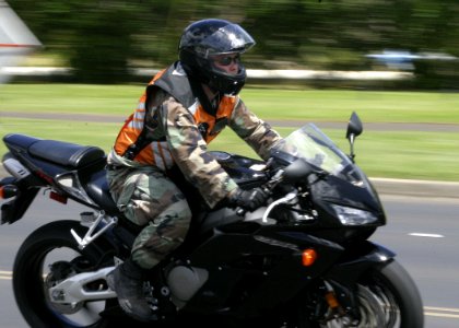 US Navy 050804-N-0879R-001 A Sailor rides his motorcycle on board Naval Station Pearl Harbor photo