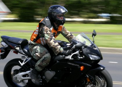 US Navy 050804-N-0879R-001 A Sailor rides his motorcycle on board Naval Station Pearl Harbor