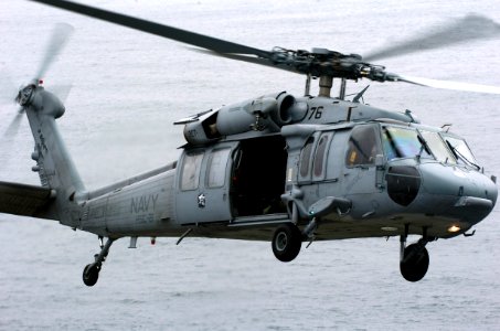 US Navy 050718-N-9866B-130 An MH-60S Seahawk helicopter, assigned to the Blackjacks of the Helicopter Sea Combat Squadron Two One (HSC-21), flies across the Pacific Ocean