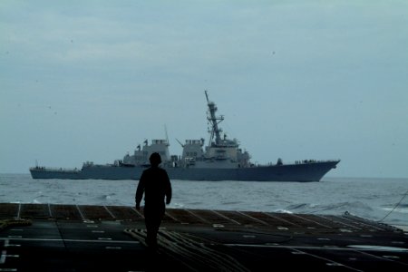 US Navy 050814-N-4772B-245 A Sailor walks in the well deck of the amphibious dock landing ship USS Harpers Ferry (LSD 49) checking lines just before a towing exercise