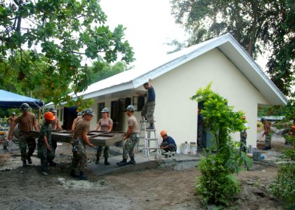 US Navy 050819-N-4772B-009 Construction personnel from Philippine Navy, and U.S. Navy Seabees assigned to Naval Mobile Construction Battalion Five (NMCB-5), put the finishing touches on a two-room schoolhouse