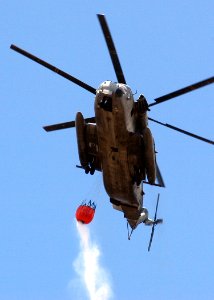 US Navy 050816-N-3019M-001 A U.S. Marine Corps CH-53E Super Stallion helicopter prepares to drop more than 2,000 gallons of water on a brushfire on the island of Oahu, Hawaii photo