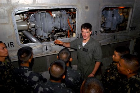US Navy 050820-N-4104L-016 Gas Turbine Systems Technician 3rd Class Daniel Miranda explains to Philippine Marines how gas turbine engines power U.S. Navy Landing Craft, Air Cushions (LCAC)