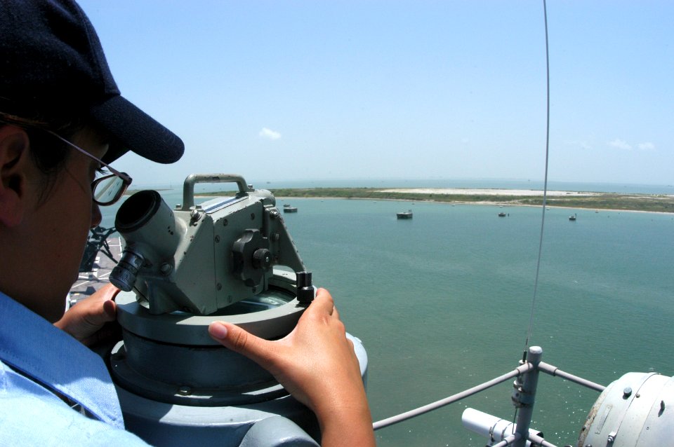 US Navy 050729-N-8154G-016 Quartermaster 3rd Class Elizabeth Barnett shoots bearings as the amphibious assault ship USS Bataan (LHD 5) departs Naval Station Ingleside, Texas