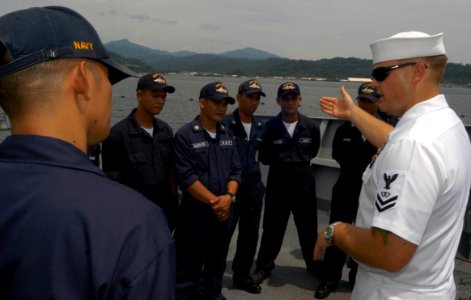 US Navy 050818-N-4104L-034 Fire Controlman 2nd Class Dean Crawford explains his visit, board, search and seizure (VBSS) security team leader role to Philippine Navy (PN) Sailors during VBSS training aboard the guided missile fr