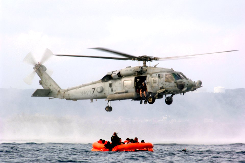 US Navy 050808-F-1740G-002 U.S. Air Force personnel assigned to the 18th Aeromedical Evacuation Squadron (AES), Kadena Air Base, Japan, prepare for a simulated rescue by a U.S. Navy HH-60H Seahawk helicopter