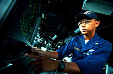 US Navy 050811-F-4883S-003 Chief Warrant Officer Enrico Orfiguerra checks the radar screen in the pilothouse aboard the guided missile cruiser USS Thomas S. Gates (CG 51)