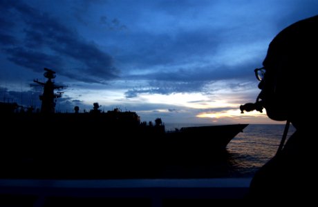 US Navy 050809-F-4883S-390 U.S. Navy Seaman Durrant Spenser watches the Chilean frigate Almirante Williams (FF 19) come along side his ship, the guided missile cruiser USS Thomas S. Gates (CG 51), during a light line transfer