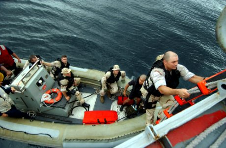 US Navy 050810-F-4883S-113 Cryptologic Technician 1st Class Joseph Legnon, a Visit Board Search and Seizure team member from the guided missile cruiser USS Thomas S. Gates (CG 51), disembarks a Panamanian vessel