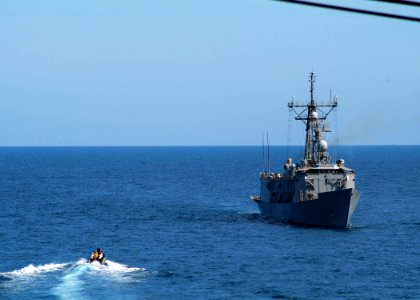 US Navy 050724-N-4772B-037 A rigid hull inflatable boat approaches the guided missile frigate USS Rodney M. Davis (FFG 60)