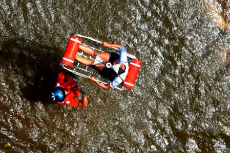 US Navy 050830-C-3721C-071 U.S. Coast Guard Petty Officer 2nd Class Scott D. Rady of Tampa, Fla., gives the signal to hoist-up a pregnant woman from her apartment during a search and rescue (SAR) flight in New Orleans