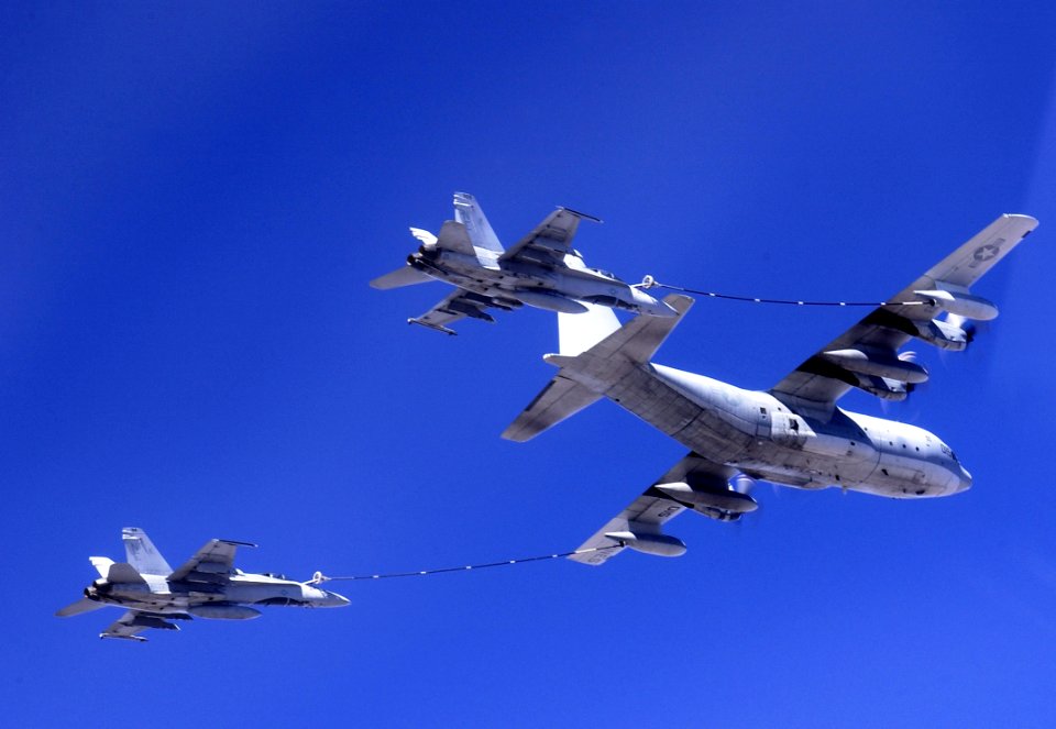 US Navy 050811-F-6655M-343 Two U.S. Navy F-A-18 Hornets assigned Strike Fighter Squadron One Five One (VFA-151) conducts aerial refueling with a Marine Corps KC-130 over Oregon during exercise Sentry Eagle 2005