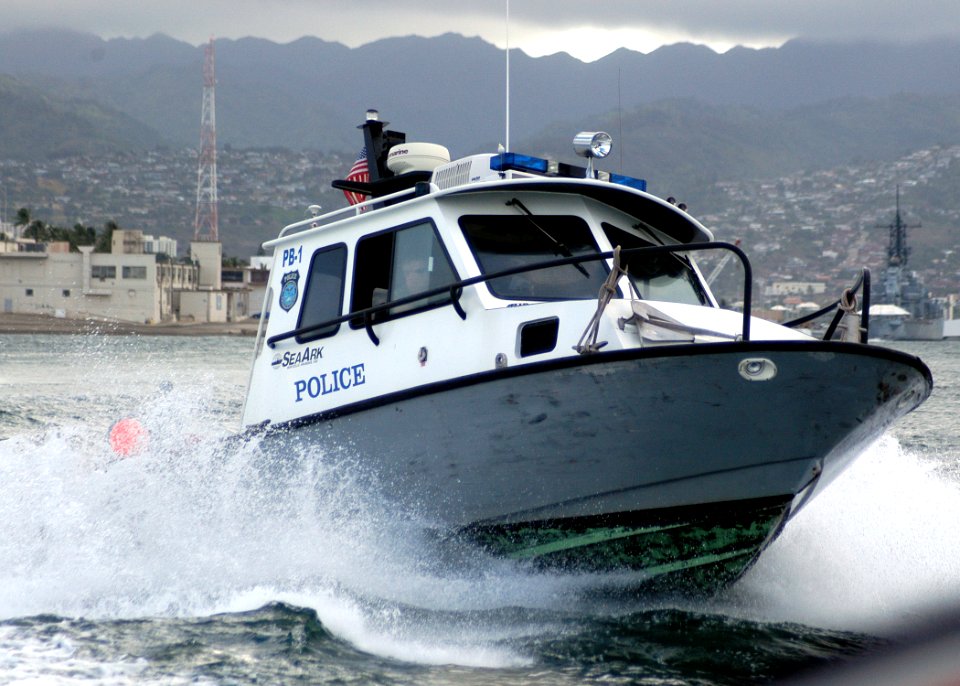 US Navy 050804-N-3019M-001 Sailors assigned to Naval Station Pearl Harbor Security, maneuver their 28-foot SeaArk patrol boat around the harbor