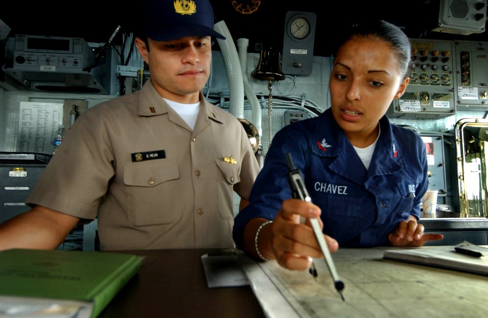 US Navy 050811-F-4883S-071 Peruvian Navy Lt.j.g. Gustavo Mejia, from the Peruvian frigate BAP Villavicencio (FM 52), listens as U.S. Navy Quartermaster 2nd Class Aurora Chavez explains the position of the guided missile cruiser