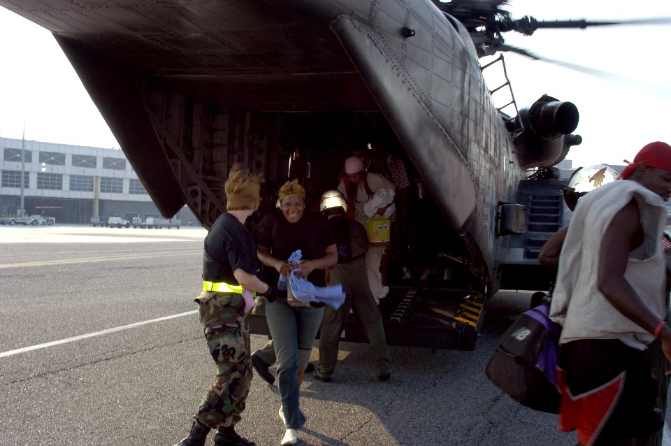 US Navy 050903-N-1467R-021 A Hurricane Katrina survivor smiles as she exits a U.S. Navy MH-53E Sea Dragon helicopter