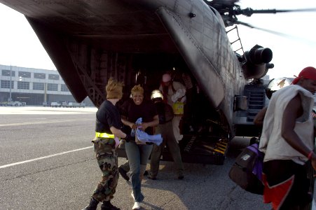 US Navy 050903-N-1467R-021 A Hurricane Katrina survivor smiles as she exits a U.S. Navy MH-53E Sea Dragon helicopter