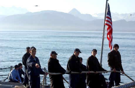 US Navy 050812-F-7169B-005 Linehandlers stationed aboard the guided missile frigate USS Crommelin (FFG 37) pull slack in from the mooring lines as the ship pulls into Alaska for a port visit prior to participating in Northern photo