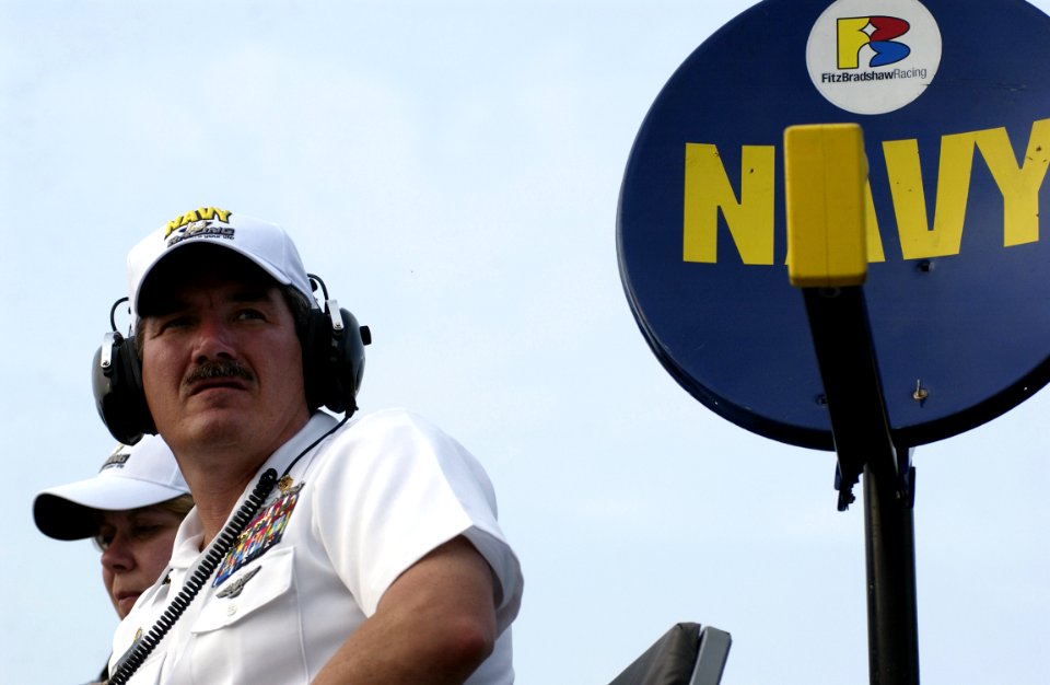 US Navy 050813-N-0962S-280 Master Chief Petty Officer of the Navy (MCPON) Terry Scott watches from the Navy's pit as David Stremme, driver of the No. 14 Navy Accelerate Your Life Dodge Charger