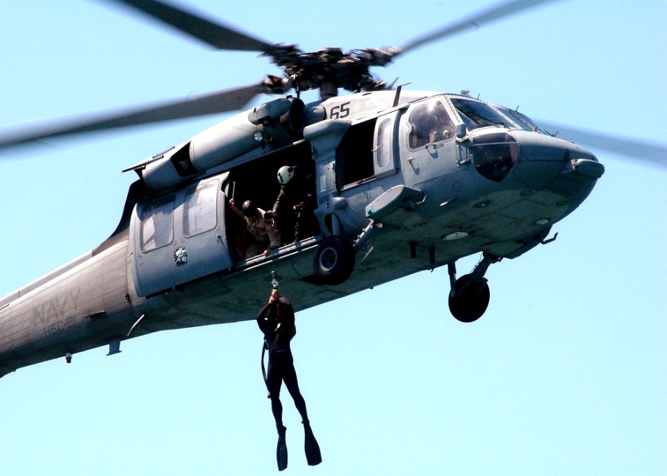 US Navy 050819-N-0716S-008 U.S. Navy Petty Officer Keith Lowe, assigned to Explosive Ordnance Disposal Mobile Unit Three (EODMU-3), Detachment 7, is hoisted down from a MH-60S Seahawk helicopter during training operations