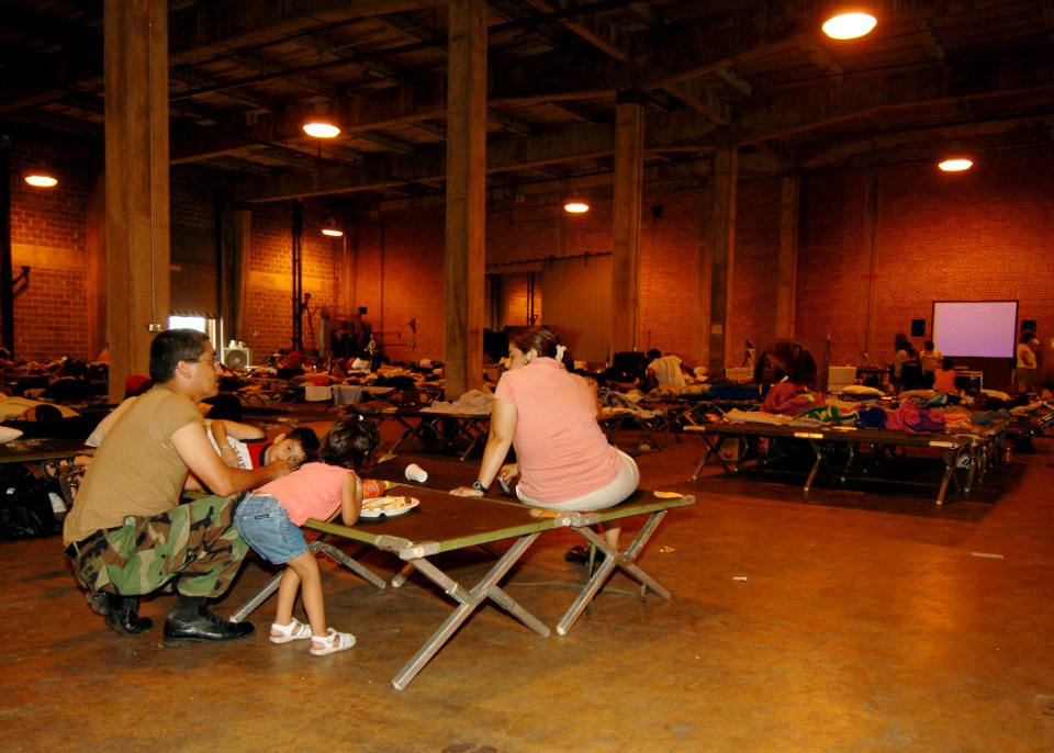 US Navy 050903-N-4374S-002 U.S. Navy Seabee, Construction Mechanic 1st Class Jesus Reyna, assigned to Naval Mobile Construction Battalion Seven (NMCB-7), takes time to eat lunch with his family