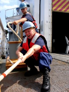 US Navy 050811-N-1464F-002 U.S. Coast Guard Seamen Susan Faulkner, foreground, and Joshua Myers pull on the steadying line