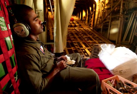 US Navy 050904-C-2023P-501 Coast Guard Petty Officer 2nd Class Miguel Martinez takes a couple of moments to relax