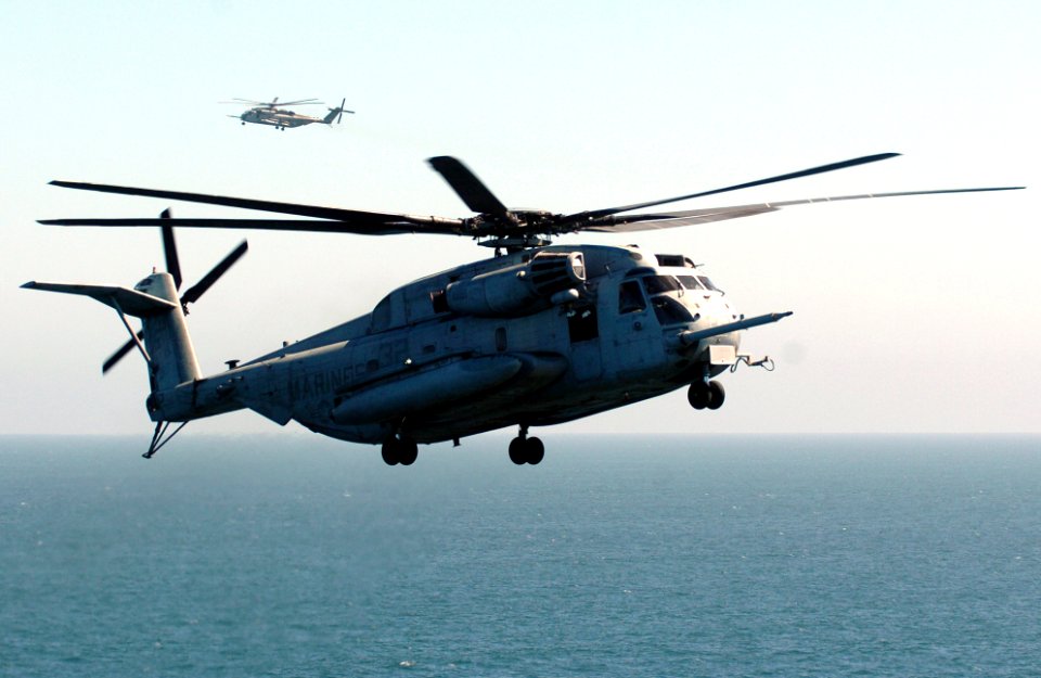 US Navy 050907-N-9866B-008 A U.S. Marine Corps CH-53E Super Stallion helicopter prepares to for landing aboard the amphibious assault ship USS Peleliu (LHA 5)