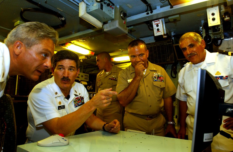 US Navy 050805-F-4883S-006 Master Chief Petty Officer of the Navy (MCPON) Terry D. Scott, second from the left, discusses a scene from a U.S. Navy capabilities video