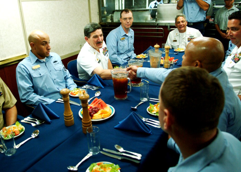 US Navy 050805-N-0962S-071 Master Chief Petty Officer of the Navy (MCPON) Terry Scott shakes hands with a chief petty officer selectee after sitting down for lunch in the chief's mess aboard the guided missile cruiser USS Thoma