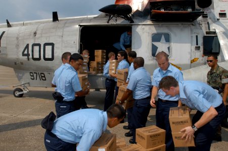 US Navy 050901-N-0438A-013 Sailors stationed on board Naval Air Station Pensacola load supplies on a UH-3H helicopter before it is transported to New Orleans to aide in disaster relief efforts for the Hurricane Katrina victims photo